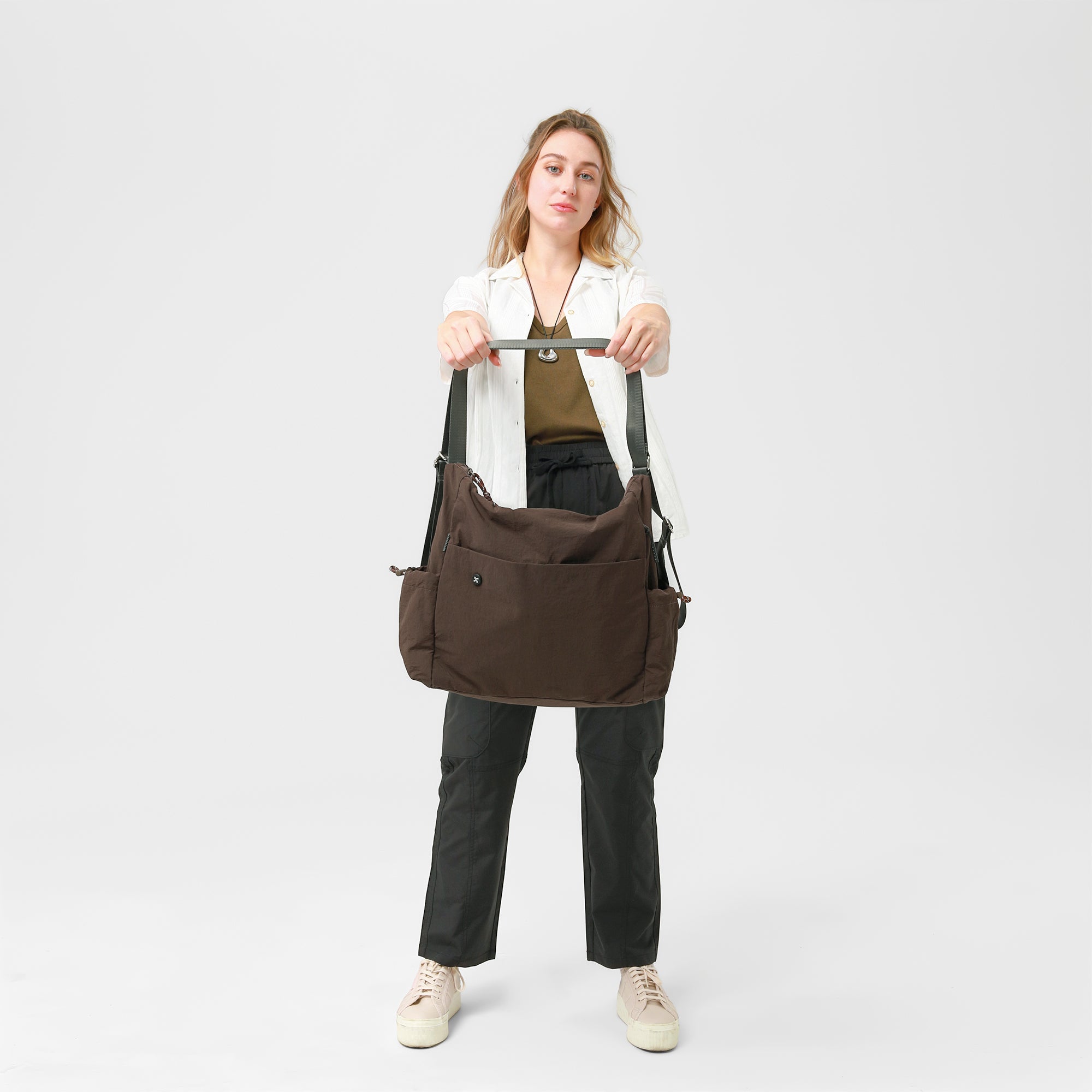 Model showcasing the Air Convert Tote bag, designed with organic fabric for urban style and air comfort.