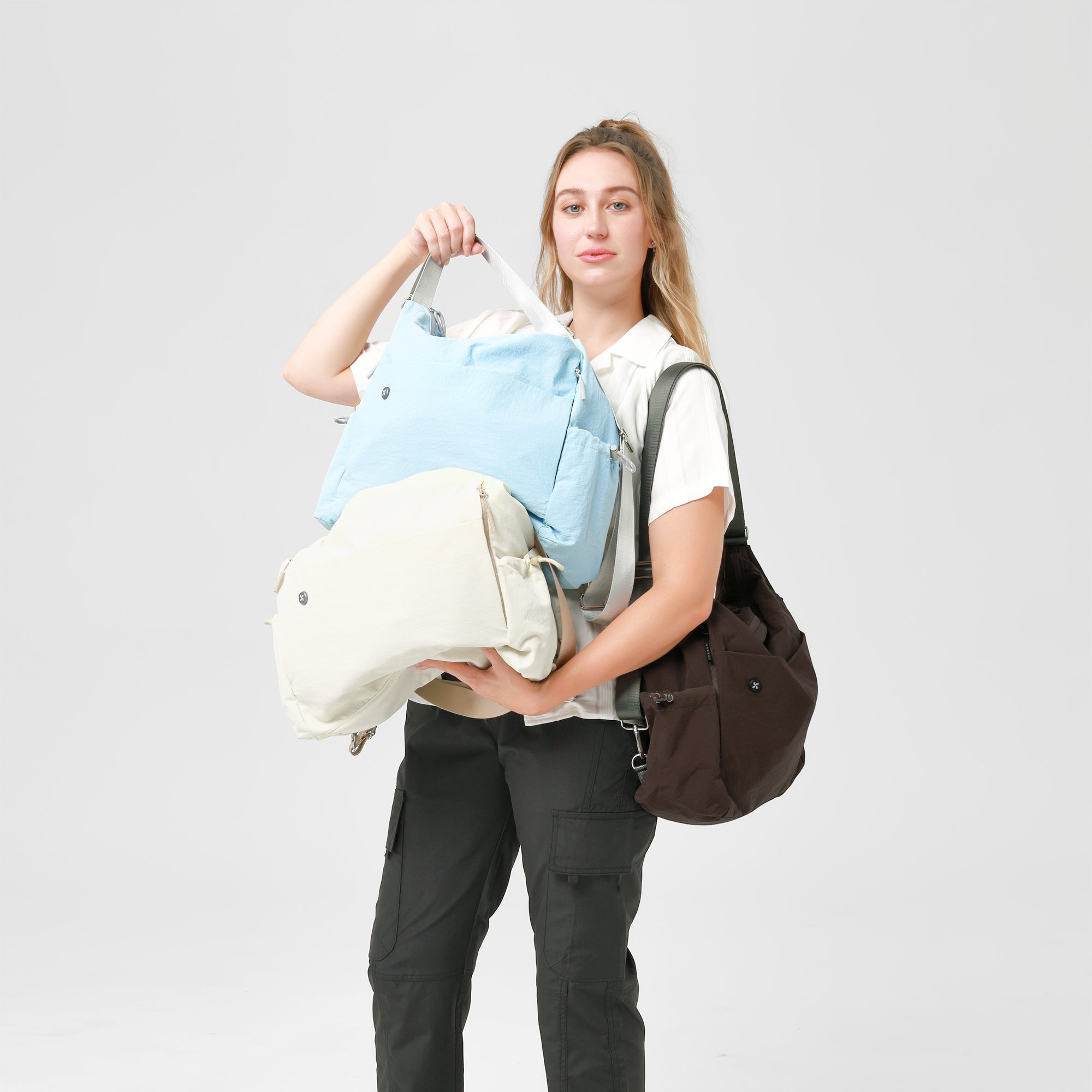Model showcasing Air Convert Tote in multiple colors, made with organic fabric for style and comfort urban living.