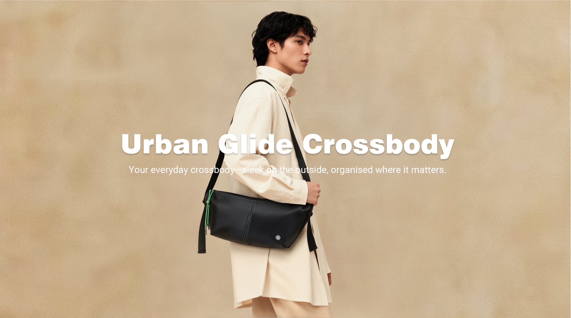Person wearing an Urban Glide Crossbody bag against a beige background
