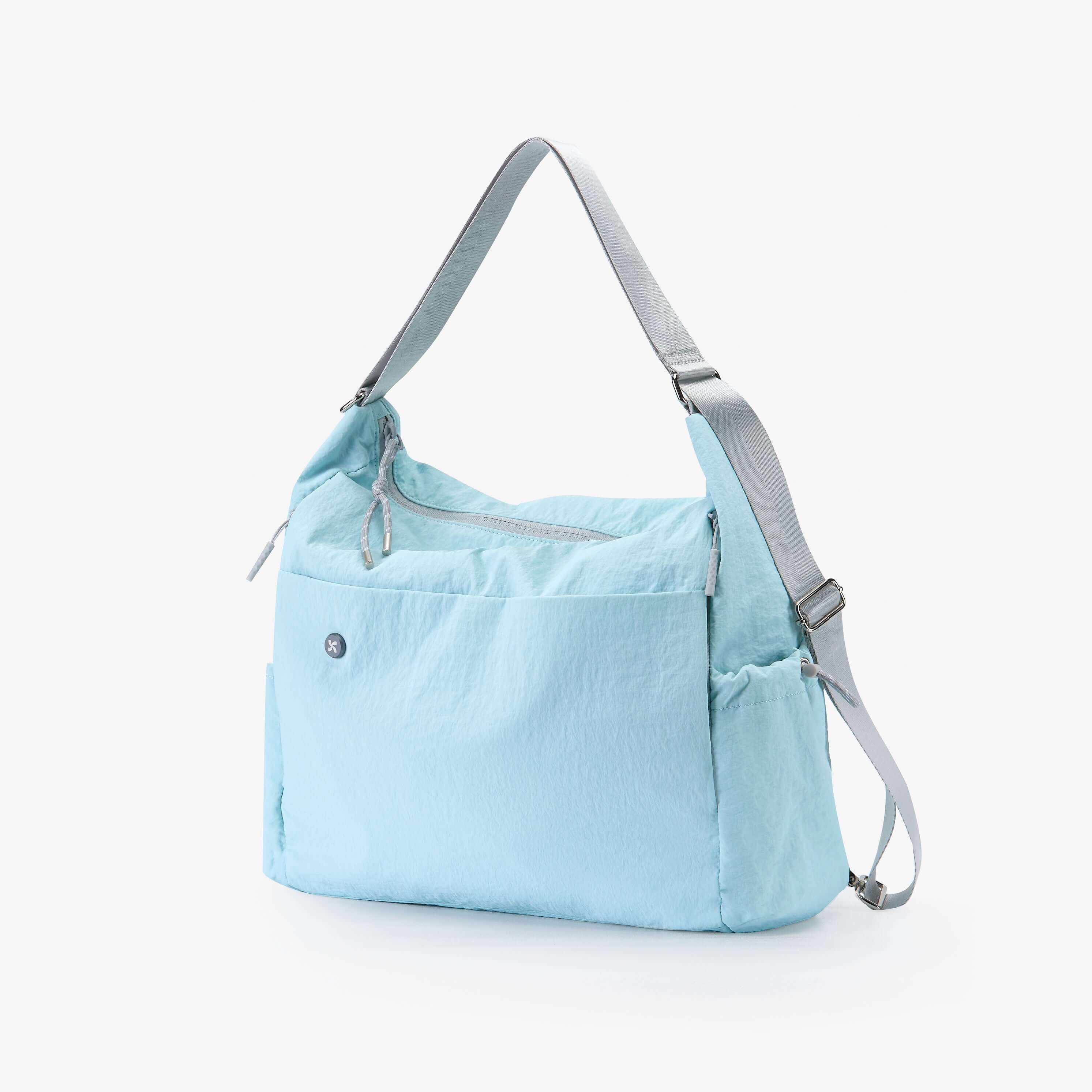 Light blue Air Convert Tote bag made from organic fabric, designed for style and comfort, adaptable for urban lifestyles.