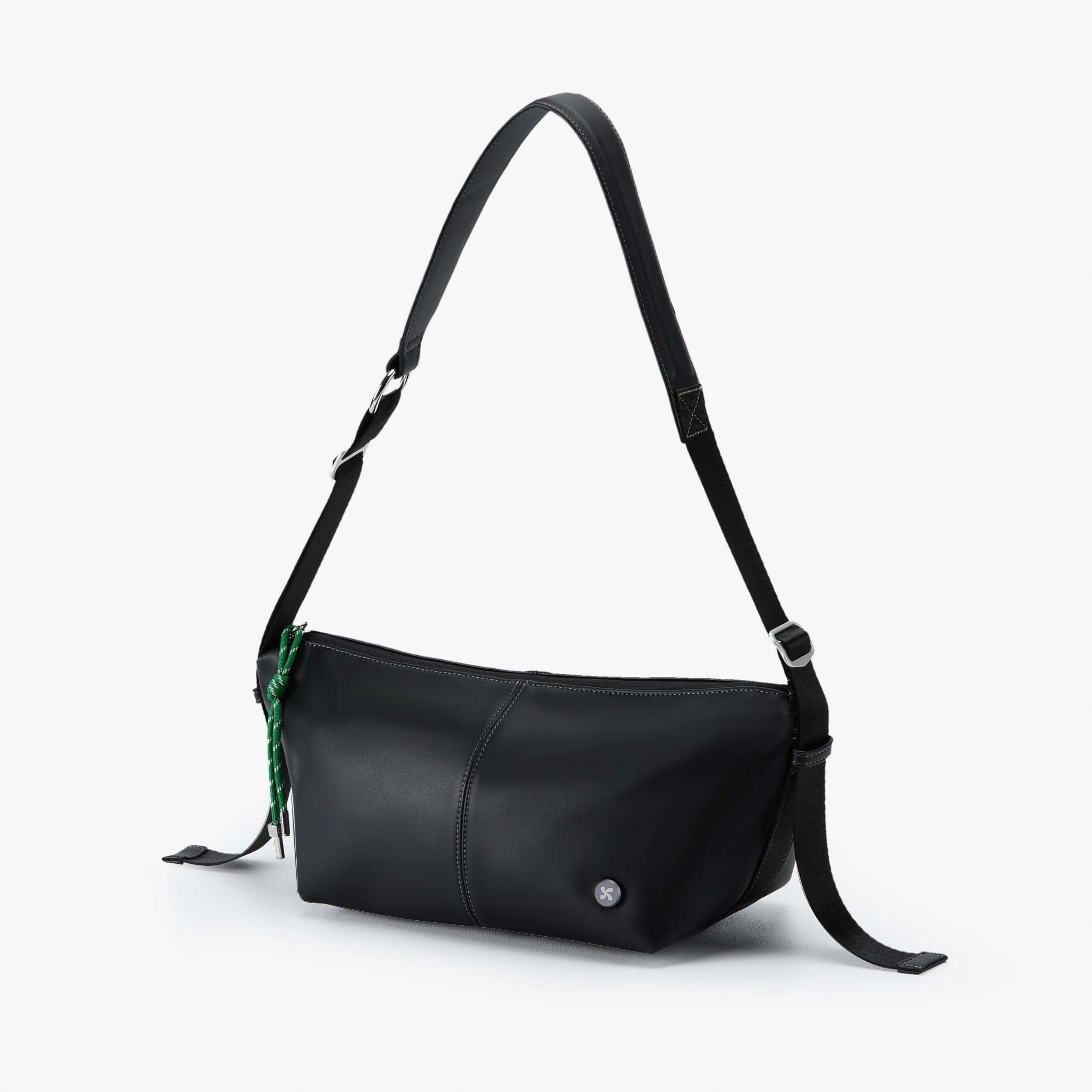 Urban Glide Crossbody bag with padded strap, crafted from coffee-ground fabric, featuring rain proof design and bold emerald detailing.