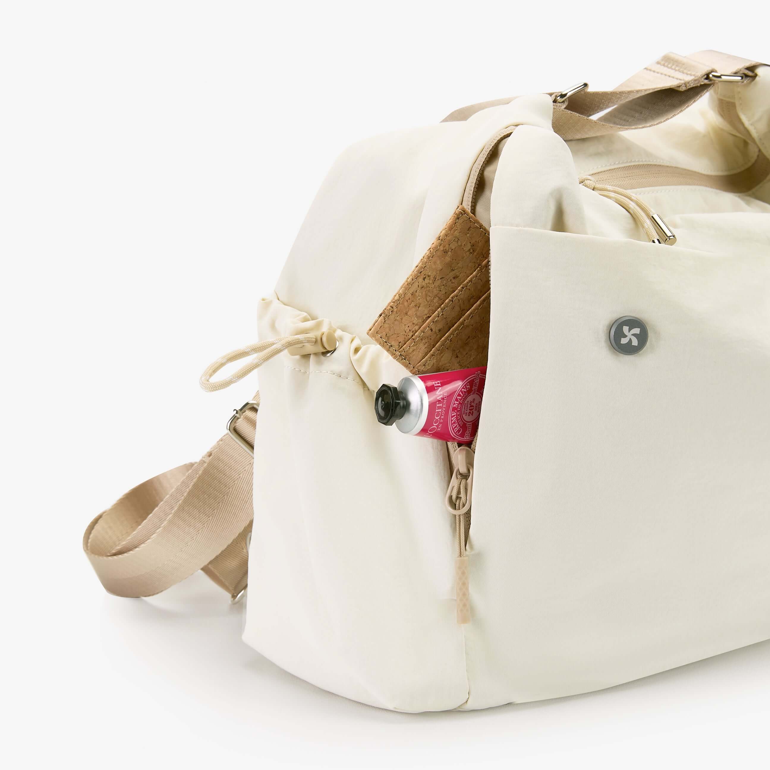 Air Convert Tote in organic fabric, featuring unique pocket design and adjustable straps for versatile use.
