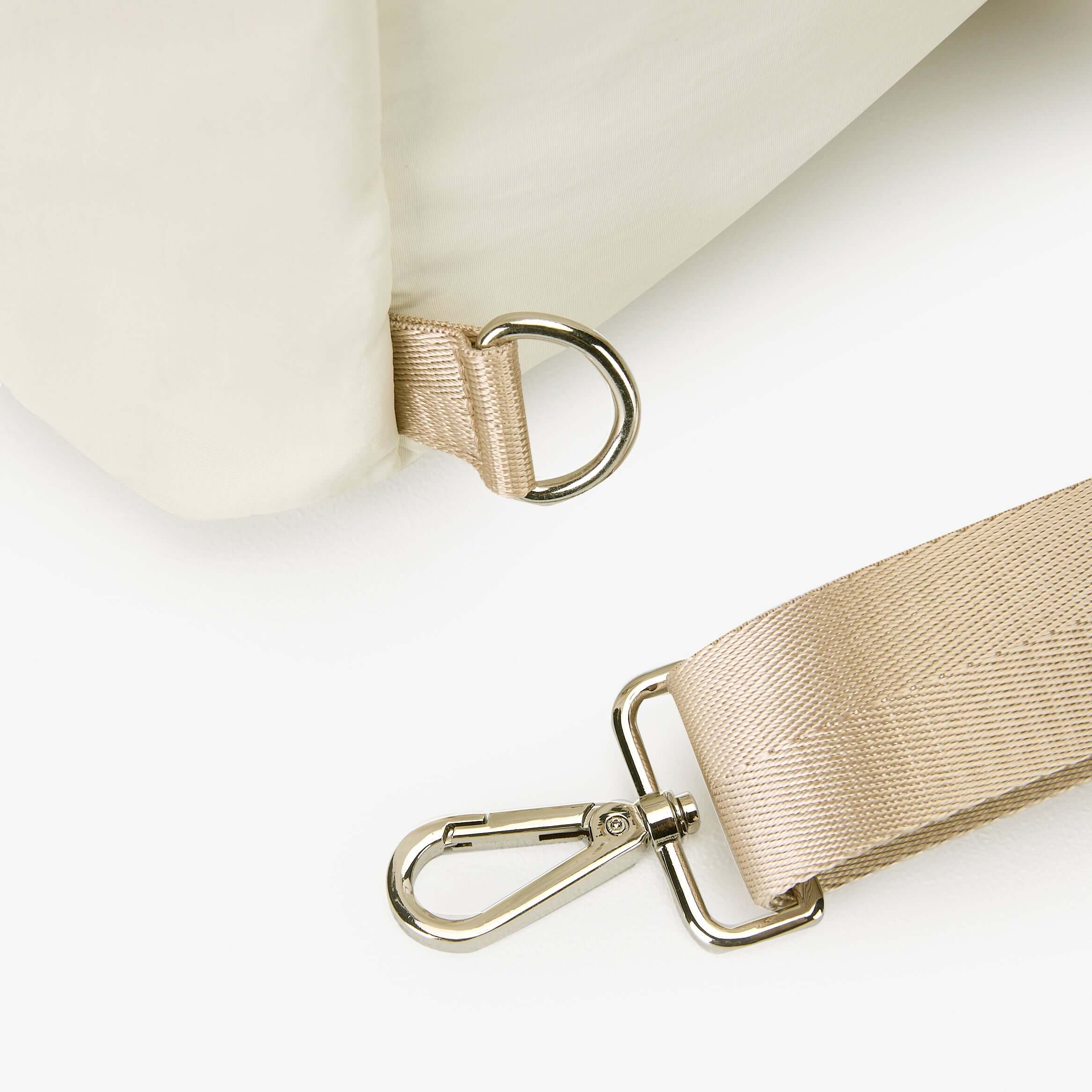 Close-up of Air Convert Tote strap with clip, showcasing organic fabric and chic design for urban style.