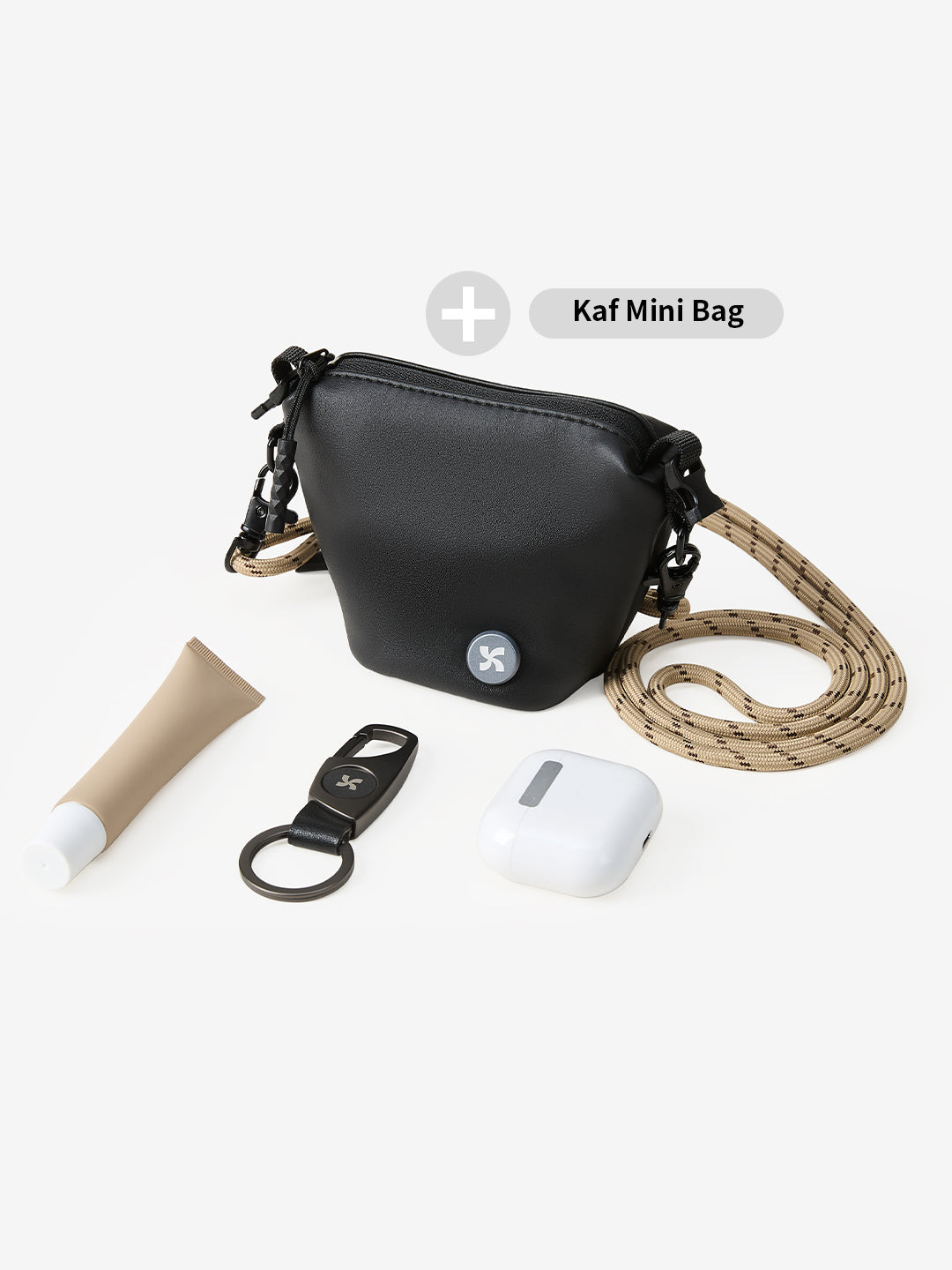 MOPAK key loop accessory featured with Kaf Mini Bag and essentials including lip balm and earbuds.